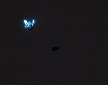 a glowing object in the dark with a yellow beam coming out of it
