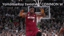 a man in a miami jersey is jumping in the air with his hands in the air