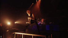 a man playing a guitar with a shirt that says and