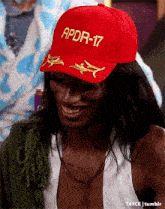 a woman wearing a red hat with apdr-17 written on it