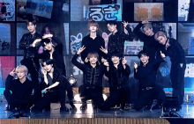 a group of young men are posing for a picture in front of a sign that says ' rm ' on it