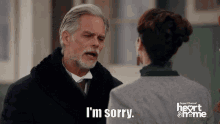 a man in a suit says i 'm sorry to a woman