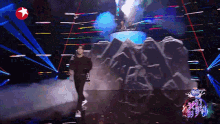 a man is walking across a stage with a star in the background