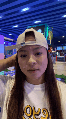 a woman wearing a hat and a shirt that says ' 6969 '