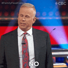 a man in a suit and tie says " no "