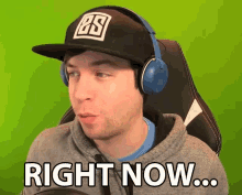 a man wearing headphones and a hat that says right now