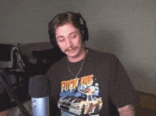 a man wearing headphones and a t-shirt that says " fuck the ftp "