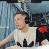 a man wearing headphones with the name davoxoxeeize on the bottom