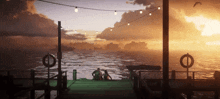 a couple sits on a dock watching the sun set
