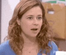 a close up of a woman 's face with a surprised look on her face .