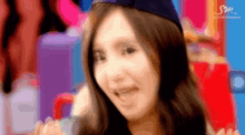 a blurry picture of a woman with a sm logo in the corner