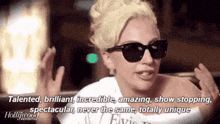 a woman wearing sunglasses is talking about being talented and brilliant