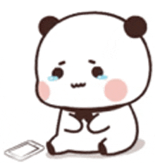 a panda bear is sitting on the ground with a cell phone in front of it .