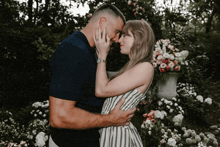 a man and a woman are hugging and looking into each others eyes