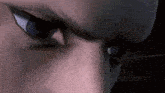 a close up of a person 's eyes with a serious look on their face