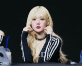 a woman with blonde hair is wearing a black and white outfit with the letter ld on it