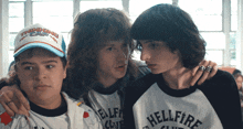 a boy wearing a shirt that says hellfire on it