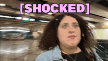 a woman is shocked and looking at the camera with the words shocked above her