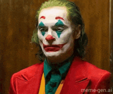 a close up of a man dressed as the joker in a red suit and clown makeup .