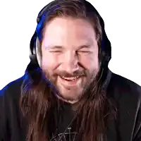 a man with long hair and a beard wearing headphones and smiling