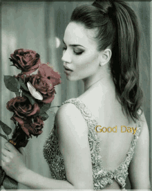 a woman in a dress is holding a bouquet of red roses and the words good day are on her back