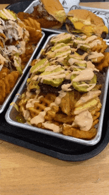 a tray of french fries with a pickle on top