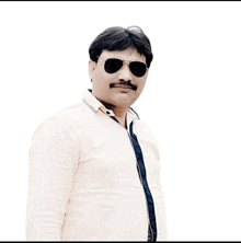 a man wearing sunglasses and a white shirt looks at the camera