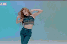 a woman with long red hair is wearing a black top and a blue top .