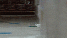 a person 's foot is visible in a hallway