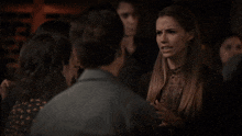 a man talking to another man in a bar