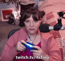 a woman playing a video game with the words twitch.tv/itstina on the bottom