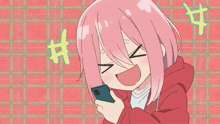 a girl with pink hair is looking at her phone