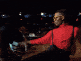 a person wearing a red jacket with a blue strap on their shoulder