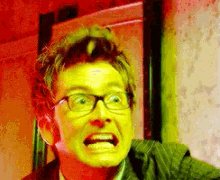 a man with glasses is making a funny face in a pixelated image
