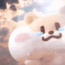 a close up of a stuffed animal with a crying face on it .