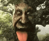a tree with a human face and tongue sticking out