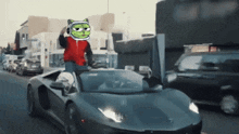 a man in a red jacket is driving a black car