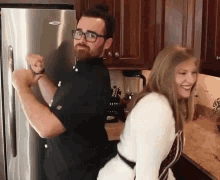 Fit Couple Cooks Booty Bump GIF