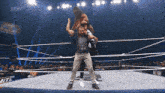 a wrestler is being lifted by another wrestler in a wrestling ring with aew written on the screen