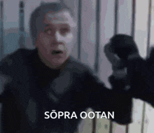 a blurred image of a man with the words sopra ootan written above him