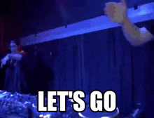 a man in a black hat says let 's go in white letters