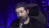 a man sitting in front of a microphone with the words do n't sleep on gay rights written above him