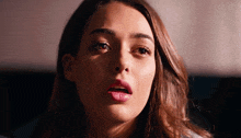 a close up of a woman with a surprised look on her face