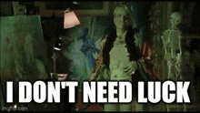 a woman standing in front of a painting with the words " i don 't need luck "