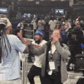 a man in a blue hat holds a sign that says ' a ' on it