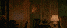 a man is on fire in a living room with a lamp