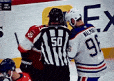a hockey player with the number 9 on his jersey stands next to a referee