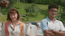 a man and a woman are standing next to each other