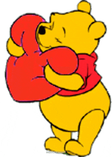 winnie the pooh is holding a red heart in his hands