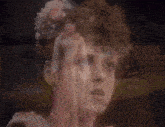 a woman in a white dress is dancing in front of a painting of boats